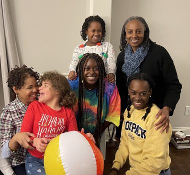 managing Angelman during the holidays | Angelman Syndrome News | Juliana holds on to her beach ball for comfort as she joins family members for a photo