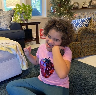 raising a child with Angelman syndrome | Angelman Syndrome News | Juliana plays with a bell that she removed from a Christmas ornament