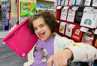 COVID-19 vaccine | Angelman Syndrome News | Sabrina's daughter Juliana smiles while listening to music after getting a COVID-19 vaccine shot.