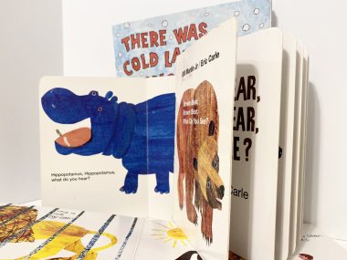 repetition | Angelman Syndrome News | photo of several picture books, with one book opened to reveal a blg, blue, smiling hippo