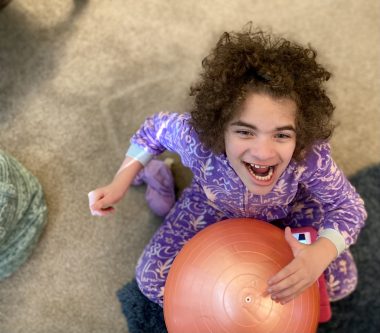 March Madness | Angelman Syndrome News | Juliana plays with a Pilates ball amid the chaos of home renovations. 