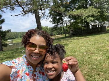 special needs and siblings | Angelman Syndrome News | Sabrina and Jessa smile and hug each other on a sunny day while picking strawberries on the last day of school last year.